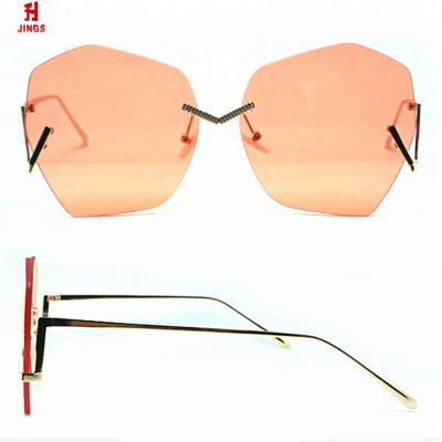 China Fashion Sunglasses 2020 Design Metal Sunglasses Shape Rimless Women Sunglasses Round Orange Polarized Lens for sale