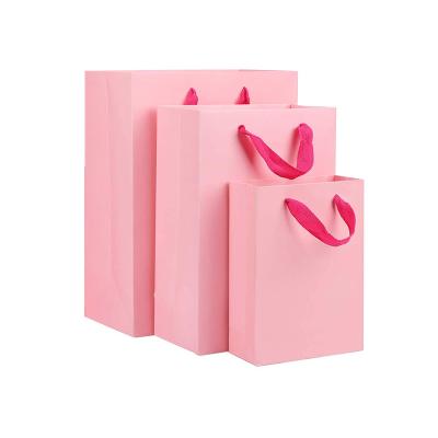 China Recyclable Factory Recycle Pink Gift Kraft Bag / Cheap Cardboard Paper Bag With Ribbon Handle for sale