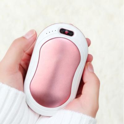 China USB Rechargeable Handheld Fast Heating Warmers 10000 mAh Portable Charger 4 in 1 Temperature Lighting/Massage/Display/Powerbank Vibration for sale