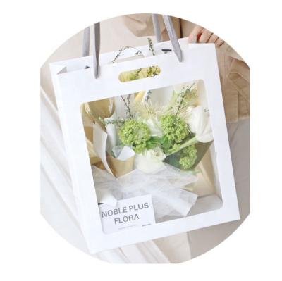 China Recycled Materials Customized Logo PVC Window Craft Paper Bag For Flowers for sale