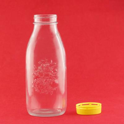 China Beverage Factory Wholesale Food Grade Embossed Logo Custom Round Shape Glass Jar With Plastic Caps for sale