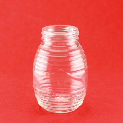 China Unique Food Design Embossed Spiricle Round Shape Glass Jar With Screw for sale