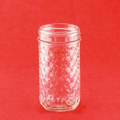 China Good Food Color Embossed Round Shape Glass Jar With Screw for sale