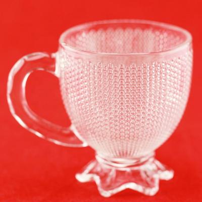 China Food Borosilicate Glass Exquisite Embossed Tea Cup With Handle for sale