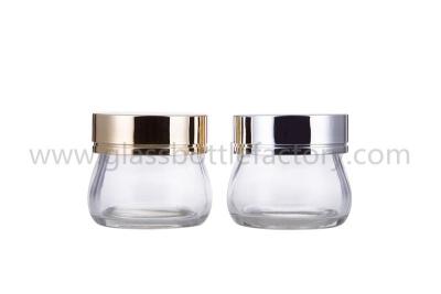 China 100g Clear New Model Glass Cosmetic Jars With Silver or Gold Lids For facemask for sale