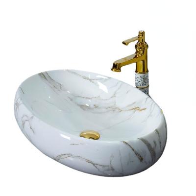 China With Faucet Nordic Minimalist Marble Ceramic Sink Over Counter Oval Basin Bathroom Or Hotel Porcelain Porcelain Wash Basin With Gold Drainer for sale