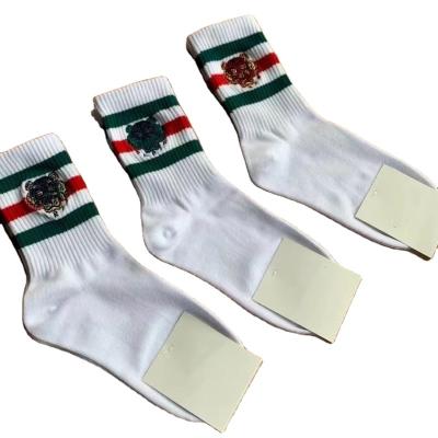 China Regular High Quality Cotton Regular Tiger Head Factory Tube Women's White Color Stripe Embroidery Daily Sports Men's Socks 2021 for sale