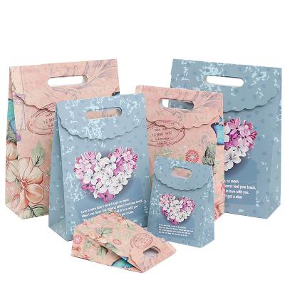 China Recycled Materials Nut Candy Printing Design Custom High Quality Special Paper Hand Held Paper Bags for sale