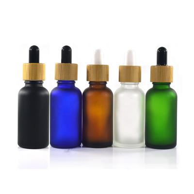 China Personal Care Wholesale Essential Oil Roller Bottle Glass Dropper Bottle With Bamboo Cap for sale