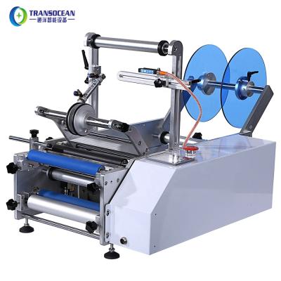 China Guangzhou Transocean tabletop manual operation semi automatic food small bottles labeling machine for round bottle with coding for sale