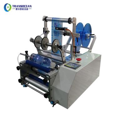 China 1000ml 500ml food water bottle manual labeling machine for round bottle sticker label for sale