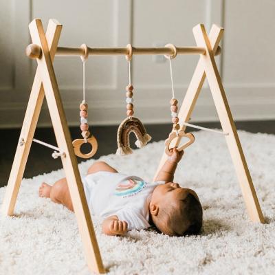 China Toy Winning Foldable Baby Play Educational Gym Frame Activity Gym with 3 Wooden Baby Teether Toys Montessori Baby Activity Gym for sale