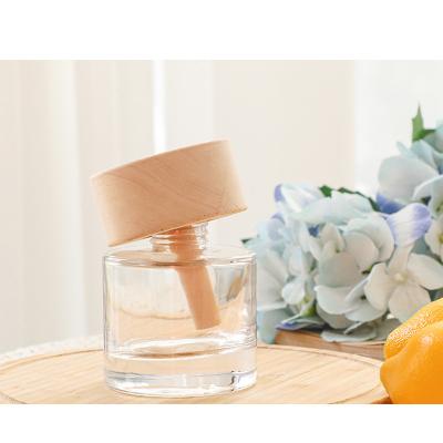 China 100ML Round shaped Reed Diffuser Glass Bottles with Beech wooden round lid for living Room for sale