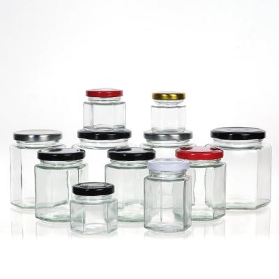 China Leeg Honingfles Glas Mini Hexagonale Honingpot 500ml 380ml 180ml 90ml 45ml met deksel Te koop