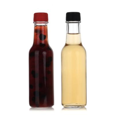 China 150Ml 250Ml 5Oz Woozy Salad Hot Sauce Glass Bottles Mini With Leakproof Black Cap en venta