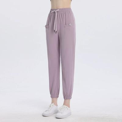 China Breathable Women Joggers Pants Side Pockets Sport Pants Logo Nylon High-Elastic Track Pants Printed Custom Made for sale