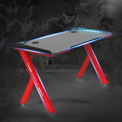 China Modern Design Convertible Gaming Table Computer R Shape RGB Gaming Desk With Cup Holder for sale