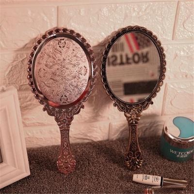 China Custom Simple Style Girl's Gift Hand Held Makeup Mirror With Logo for sale