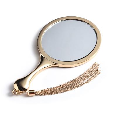 China Personalized Zinc Alloy Mirror Round Metal Handle Gift Female Makeup Mirror Around Single Mirror for sale