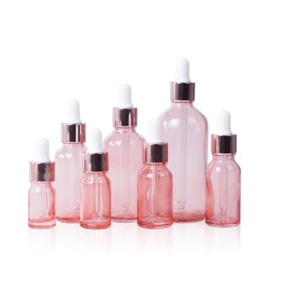 China Fashion Pink Glass Bottle 10ml 20ml 30ml 50ml 100ml Rose Gold Essential Oil Dropper Personal Care Dropper Bottle for sale