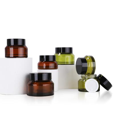 China 15g cosmetic 30g 50g Amber Glass Cosmetic Jars with black lids around green glass jars with inner layers for sale