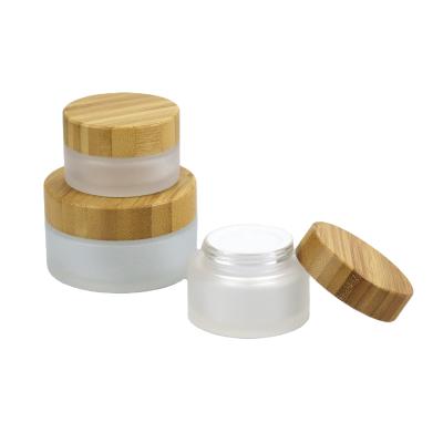 China Skincare creams luxury cosmetic bamboo glass jar 15g 30g 50g 100g cream frosted cosmetic glass jars bottles with bamboo lid for sale