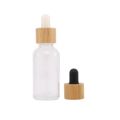 China Cosmetic in stock 30ml 1oz clear glass dropper bottle with bamboo wooden cap for sale