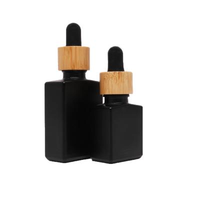 China 15ml 30ml 50ml Cosmetic Matte Black Rectangle Glass Dropper Bottle With Bamboo Cap for sale