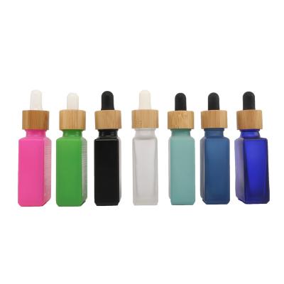 China 30ml Glass Bottle 1oz Rectangle Shape Glass Cosmetic Empty Essential Oil Bottle With Bamboo Dropper Cap for sale