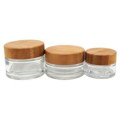 China Face Oil Frosted Eye Cream Face Cream Round Glass Jars With Bamboo Lids 5/15/30/50/100g for sale