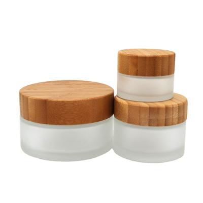 China Face Oil 30g 50g Color Empty Frosted Glass Jar With Bamboo Lid for sale