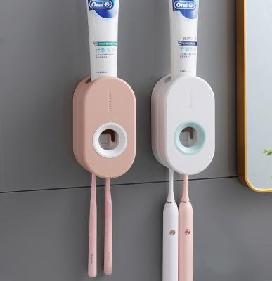 China Hot Selling Stocked No Drill Wall Mounted Plastic Holder Toothpaste Toothpaste Squeezer Automatic Toothpaste Dispenser for sale