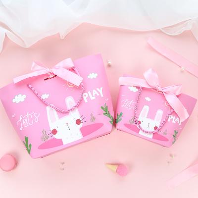 China Recycled Baby Girl Carrying Pink Paper Bag Cartoon Custom Gift Materials Hundred Day Treats With Hand Gift for sale