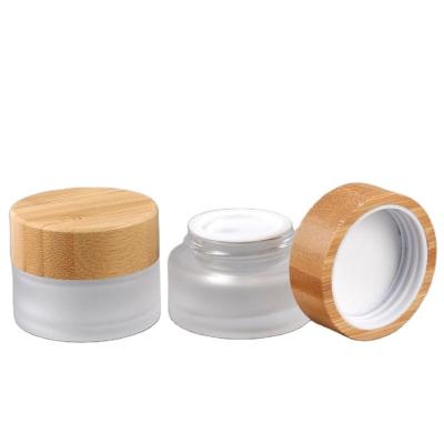 China Cosmetic Clear Frosted cream jar with lid Round 5g 10g 30g Frosted Bamboo Lid Glass Cream Jars for sale