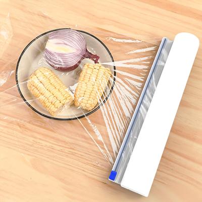 China New Sustainable Suction Cup Household Kitchen Plastic Cutter Plastic Wrap Dispenser With Cutter for sale