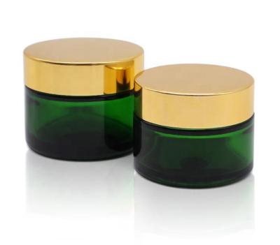 China Personal Care 20G 30G 50G Glass Empty Cosmetic Cream Jar Green Glass Bottle With Cap Plastic Glass Tin Can for sale