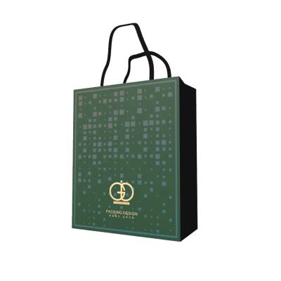 China Modern Luxury Custom Printed Dark Green Paper Handbag With Ribbon Handles Luxury Paper Bags for sale