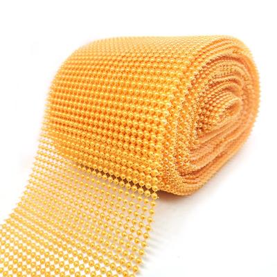 China Factory direct sale viable orange color apparel accessories lace up beaded trim pearl plastic mesh fabric for spats top decoration for sale