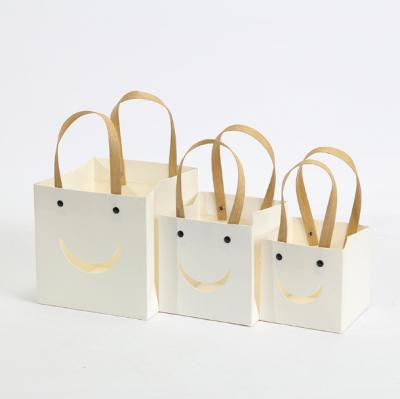 China Recycled Materials Kraft Paper Shopping Handle Gifts Bag Smiley Creativity Party Bag For Shopping Gifts Packaging for sale