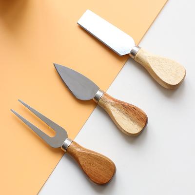 China Viable Amazon Handle Popular Cheese Instruments Wooden Handle Stainless Steel Cheese Fork Knife Kitchen Cheese Tools for sale