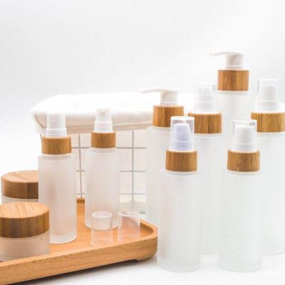 China Personal Care Whole Set Garfish With Bamboo Lids Clear Glass Frost Lotion Pump Bottle With Bamboo Lid for sale