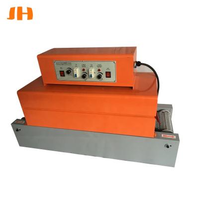 China Semi Automatic Beverage Shrink Tunnel Wrapper Cling Film Heat Tube Cutting Shrink Wrapping Machine for sale