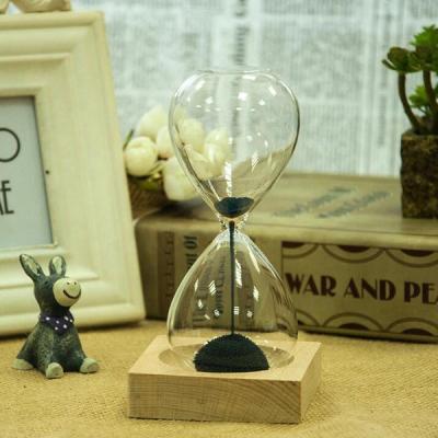 China Art Decor Iron Filings Hourglass with Sand Timer Wooden Bottom Magnetic Hourglass for sale