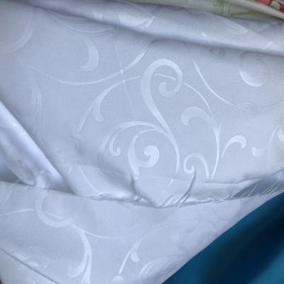 China Bed Sheet Fabric Shrink-Resistant White Embossed Hot Sale Polyester Microfiber Brushed Fabric for sale