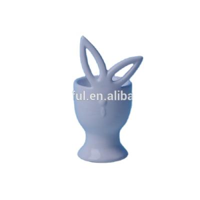 China Viable Artistic White Glazed Ceramic Egg Cup with Cute Rabbit Design for sale