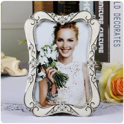 China Alloy European white metal photo frame retro inlaid diamond luxury picture frame set table 6/7/10 lovers photo studio photo frame for sale