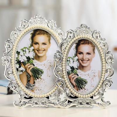 China Alloy Metal photo frame custom classical hollow European style table 6 inch 7 inch seven inch wedding photo frame photo frame birthday for sale