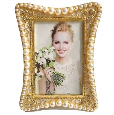 China Alloy Light luxury white pearl photo frame can be hung on the wall simple 6/7/8/10 inch desktop display table graduation photo frame for sale