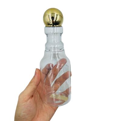 China Single Sale Cosmetic PET Plant Shape Essential Oil Bottle 300ml Clear Shampoo Bottle With Gold Cap for sale