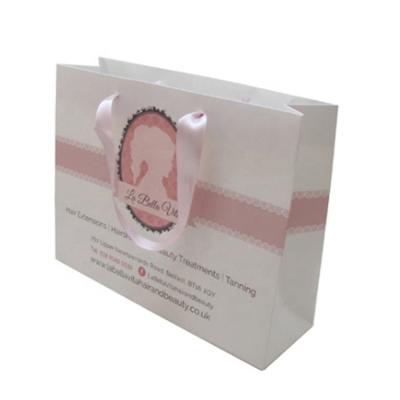 China Recycled Materials High Quality White Pink Shopping Bags Custom Paper Ribbon Handles With Your Own Logo for sale